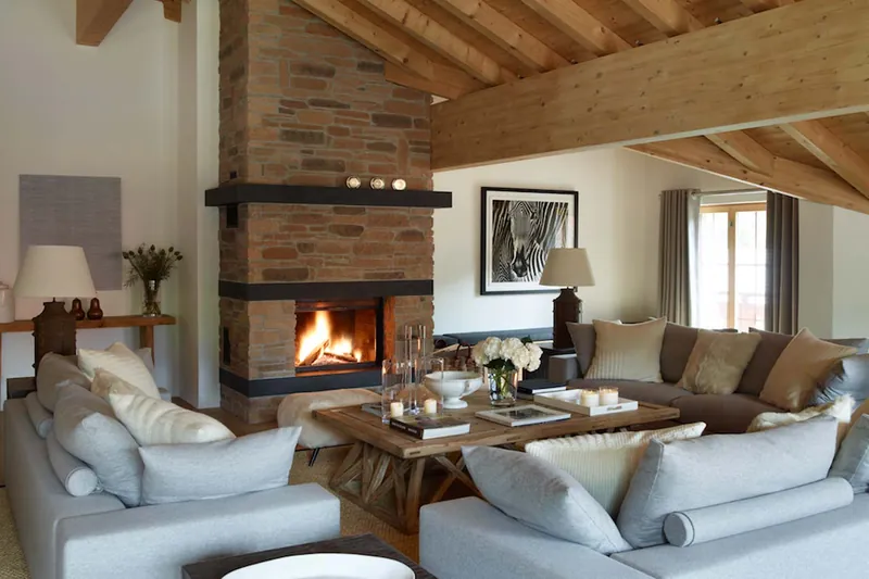 The lounge with a stone fireplace at Penthouse Emiko, Klosters