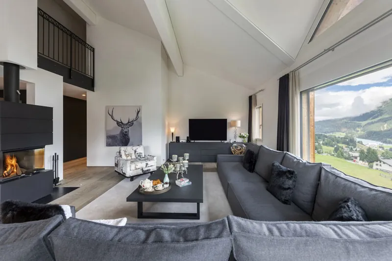 The double-height living room and fireplace at Chalet Kyla, Davos