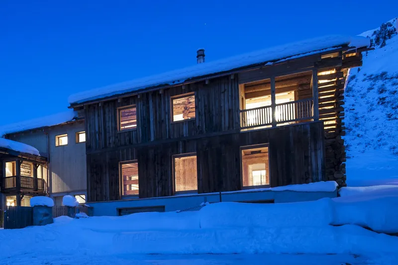 Chalet Shelley, a converted barn in Sertig, at blue hour in the snow