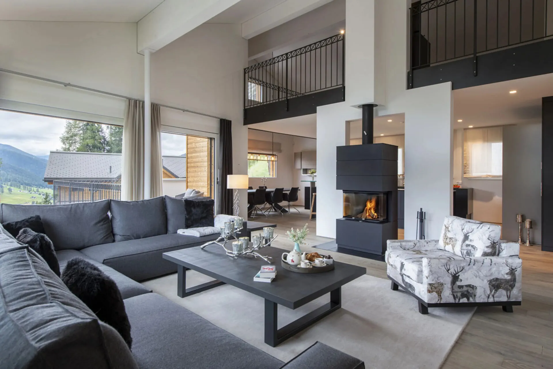 The open-plan living room of Chalet Kyla, Davos, with mountain views